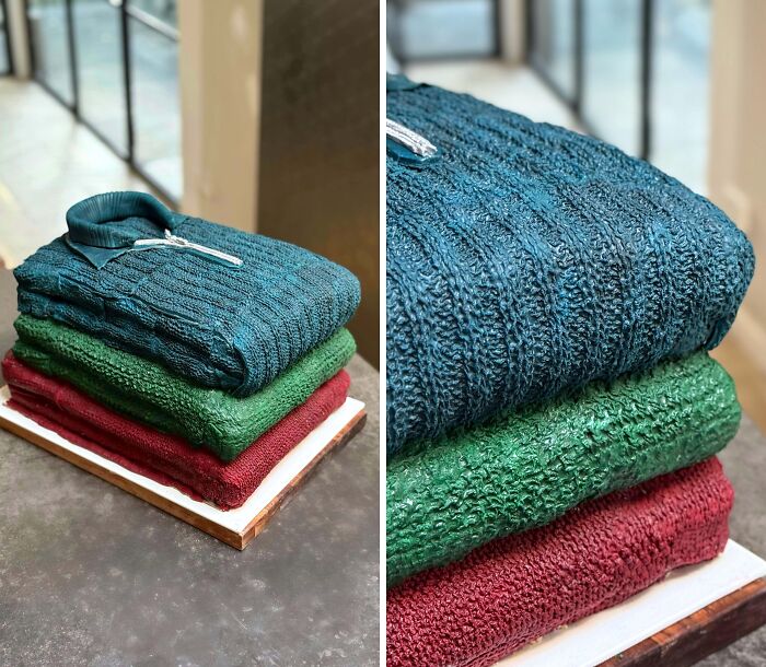 Masterfully crafted cakes designed to look like folded textured sweaters stacked on a table in natural light.