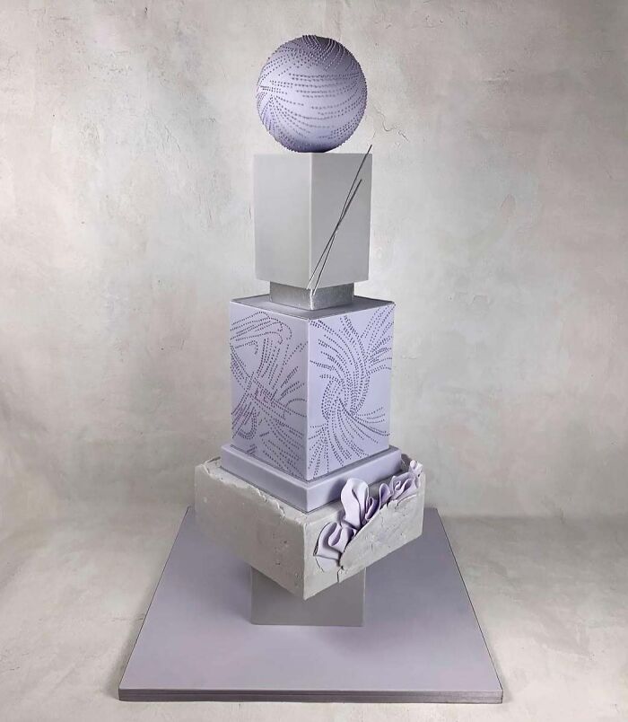 Modern sculpted cake with geometric shapes and intricate designs showcasing masterfully crafted cake creativity.