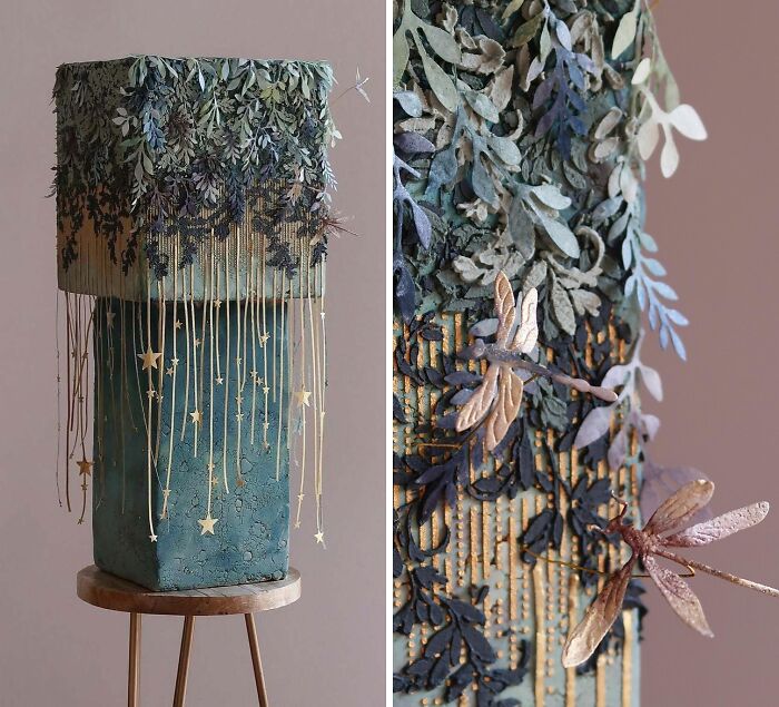 Tall masterfully crafted cake with intricate foliage and hanging stars showcasing human creativity in cake design.