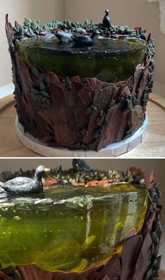 Detailed masterfully crafted cake designed as a forest pond with ducks and underwater turtle, showcasing creativity in cake art.