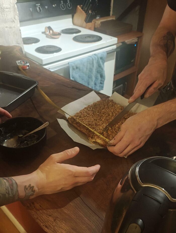 Two people in a rented kitchen cutting a homemade dessert, illustrating rental nightmares and landlord shortcuts exposed.