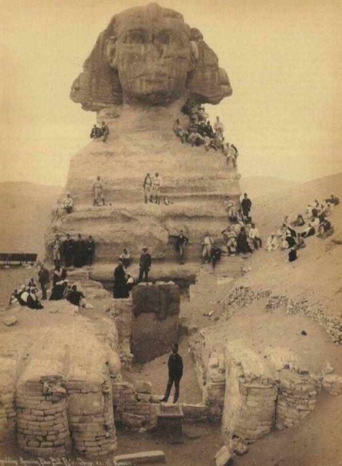Vintage photograph of the Great Sphinx with people around, showcasing incredible photographs from Ancient Egypt history.