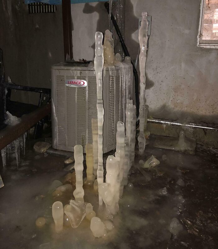 Frozen icicles formed around a heating unit in a basement, showcasing unique challenges in people’s different jobs.