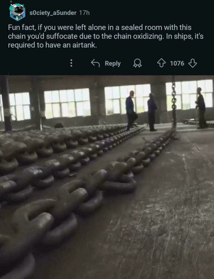 Huge metal chain links laid out inside a large warehouse with people standing, related to weirdest math problems solving.