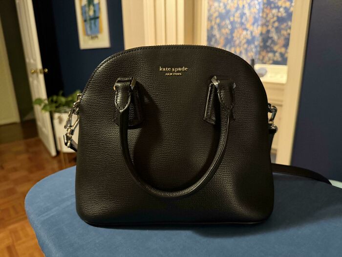 Black Kate Spade handbag found at a secondhand store, showcasing a cool and unexpected fashion surprise.