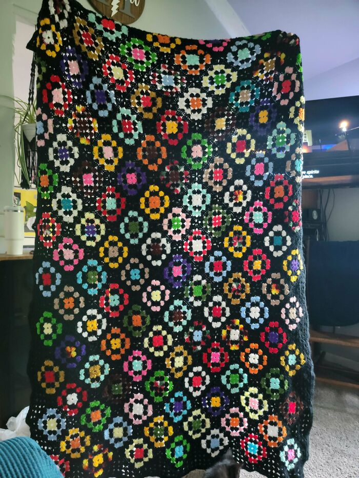 Colorful crocheted blanket with floral patterns found at secondhand stores delivering cool, unexpected surprises.