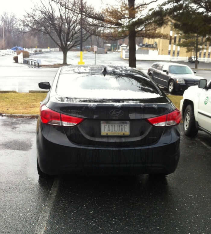 Black Hyundai with a personalized license plate reading FAILURE, one of the hilarious personalized license plates that made strangers do double takes.