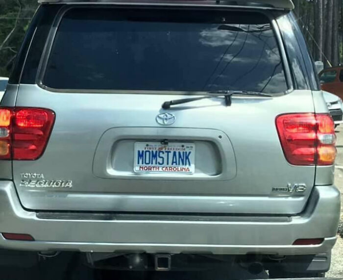 Silver Toyota Sequoia SUV with a personalized North Carolina license plate reading MOMSTANK, showcasing humorous custom plates.