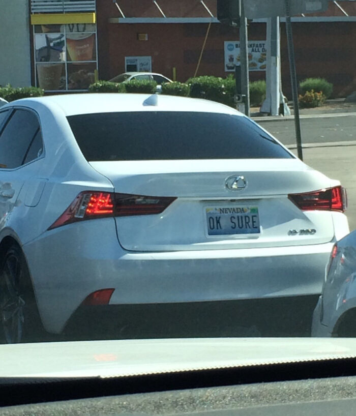 White Lexus with a personalized Nevada license plate reading OK SURE, one of many hilarious personalized license plates.