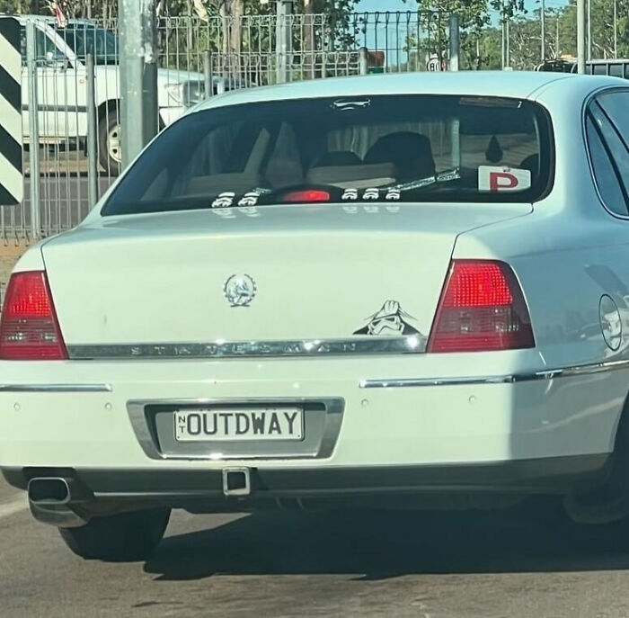 White car with a personalized license plate reading OUTDWAY, showcasing one of the hilarious personalized license plates.