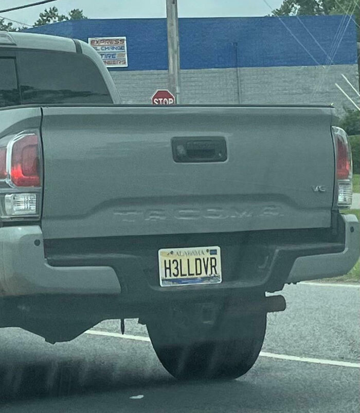 Personalized license plate H3LLDVR on gray Tacoma truck, showcasing one of the hilarious personalized license plates that catch attention.