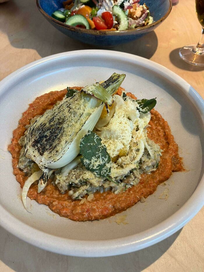 Plate of food with grilled vegetables and sauce, an example of outrageous meals that look nothing like menu photos