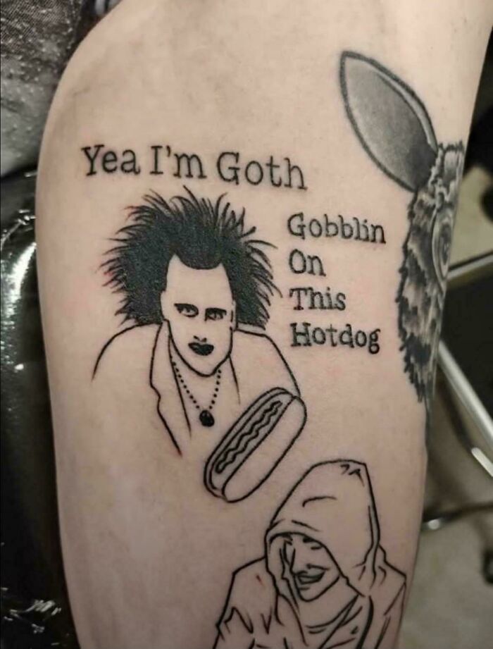 Tattoo of a goth character holding a hotdog with humorous text, part of hilarious posts meant to make you laugh.
