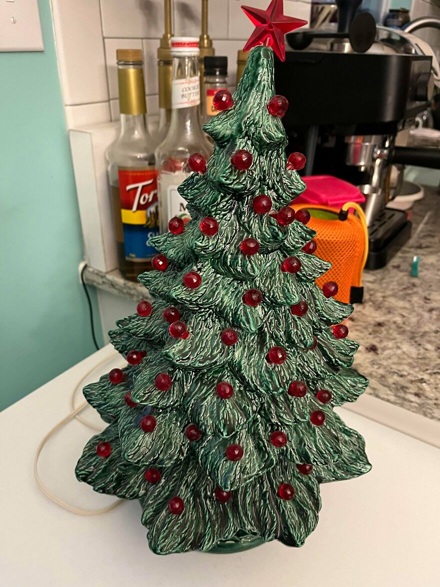 Vintage ceramic Christmas tree decoration with red bulb lights and a red star on top, showcasing nostalgic holiday decor.