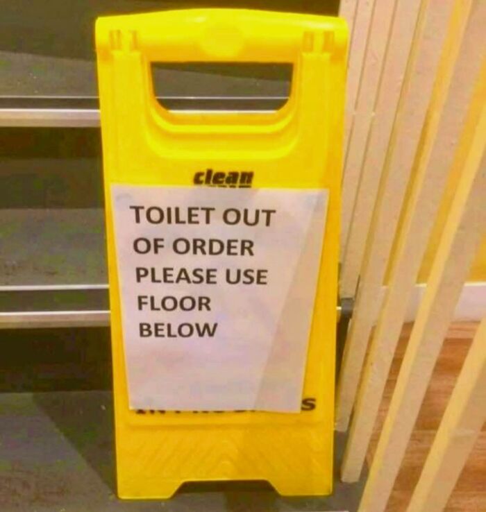 Yellow caution sign with a humorous out of order toilet notice, a funny meme to brighten dark and cold winter days.