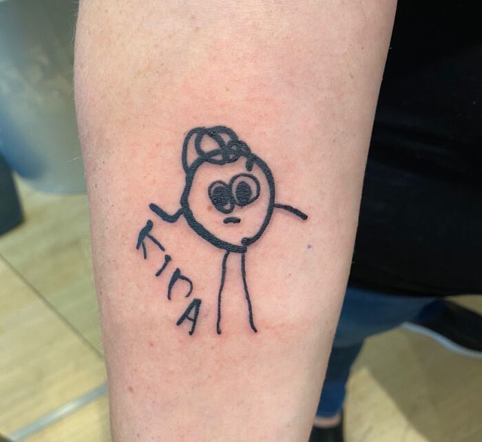 Simple wholesome tattoo of a childlike drawing with the name Tina on a person's forearm, showcasing meaningful ink.