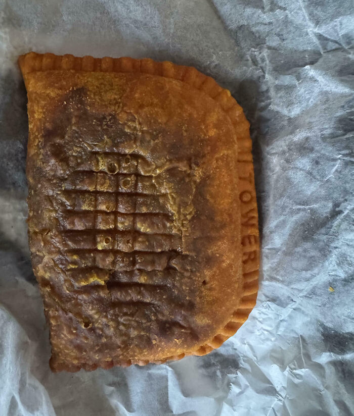 Overcooked, misshapen fried meal that looks nothing like the menu photos, wrapped in crumpled wax paper.