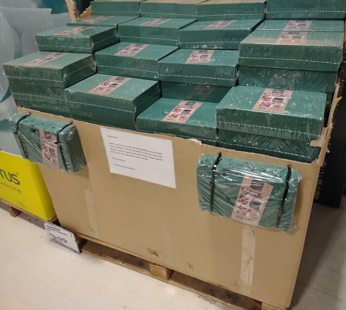 Stacks of green boxes wrapped in plastic on a pallet in a warehouse setting, showcasing different jobs that make a 9-to-5 bearable.