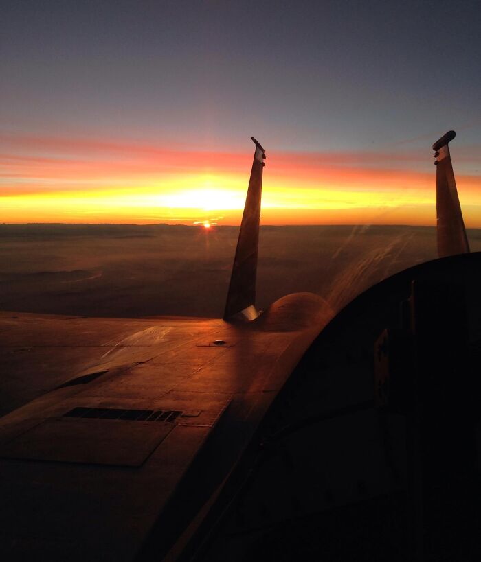 Sunset view from an airplane wing, showcasing a fascinating moment from different jobs that make a 9-to-5 more bearable.