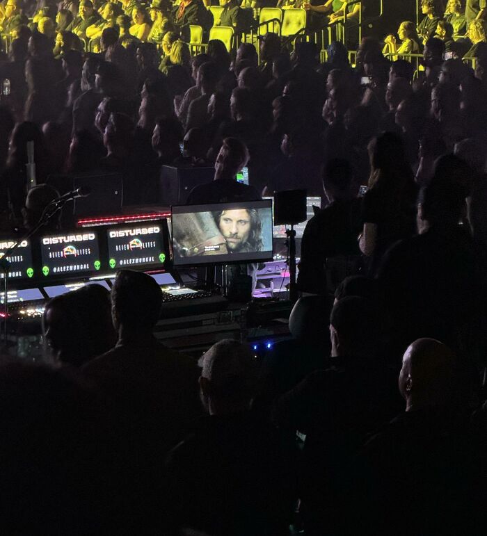 Live event production team managing audio and video equipment during a concert, showcasing unique job photos.