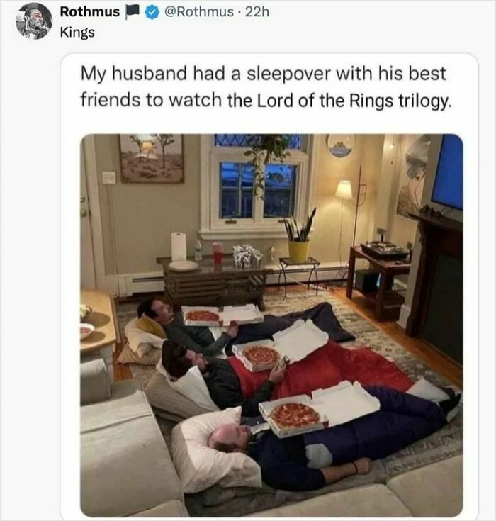 Three men having a sleepover watching movies, lying on the floor with pizzas, a cheerful meme about wasting time online.