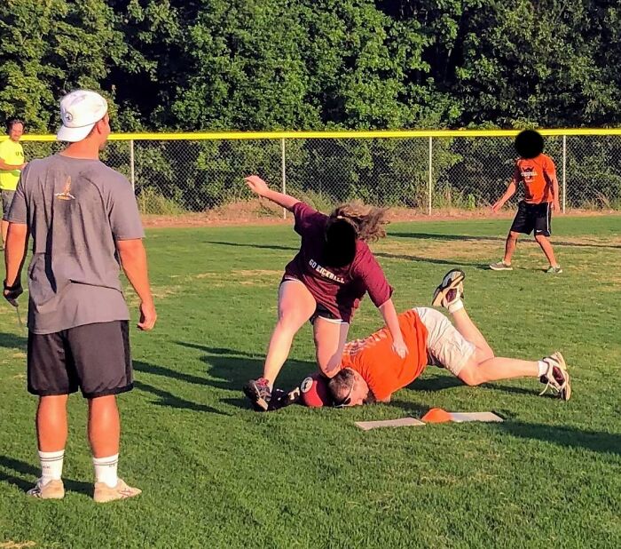 People playing baseball in funny and interesting moment caught at the perfect time on a sunny day outdoors.