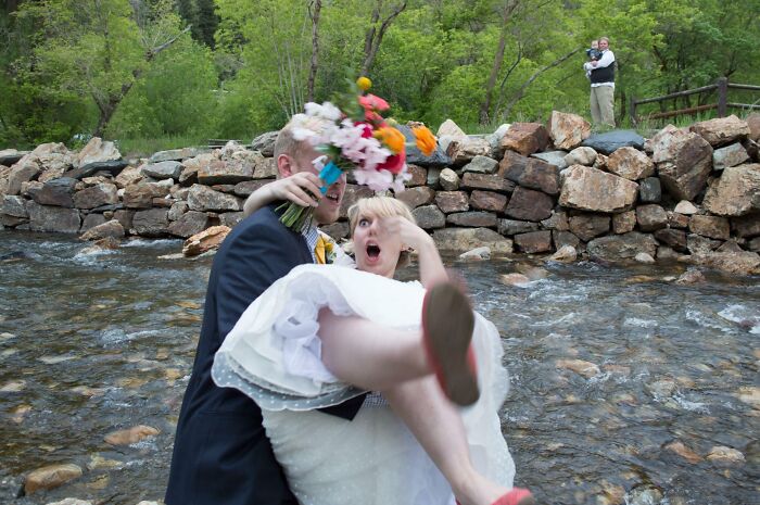 Bride and groom at the perfect time as the bride’s bouquet hits the groom’s face in a funny and interesting moment.