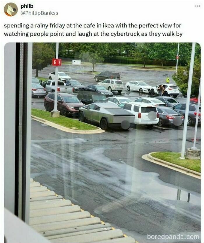 View from a rainy cafe at IKEA parking lot with people laughing and pointing at the Cybertruck parked among other cars.