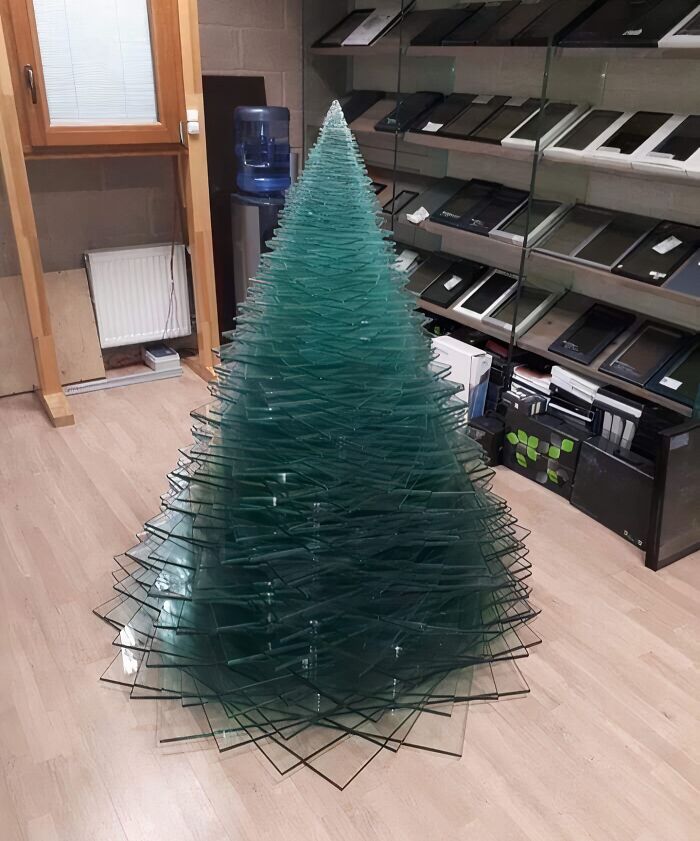 Creative workplace Christmas decoration featuring a modern tree made from stacked glass panes, impressing with unique design.