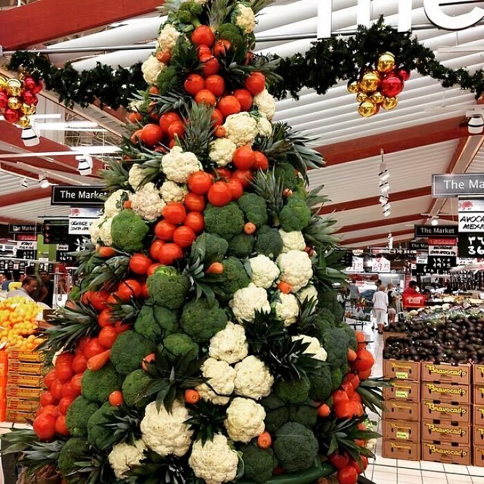 Christmas decorations with creative vegetable and fruit arrangements in a workplace market setting, impressing with originality.