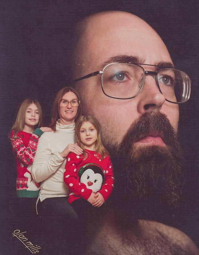 Awkward family Christmas photo with smiling mother and daughters in festive sweaters and large superimposed bearded man face.