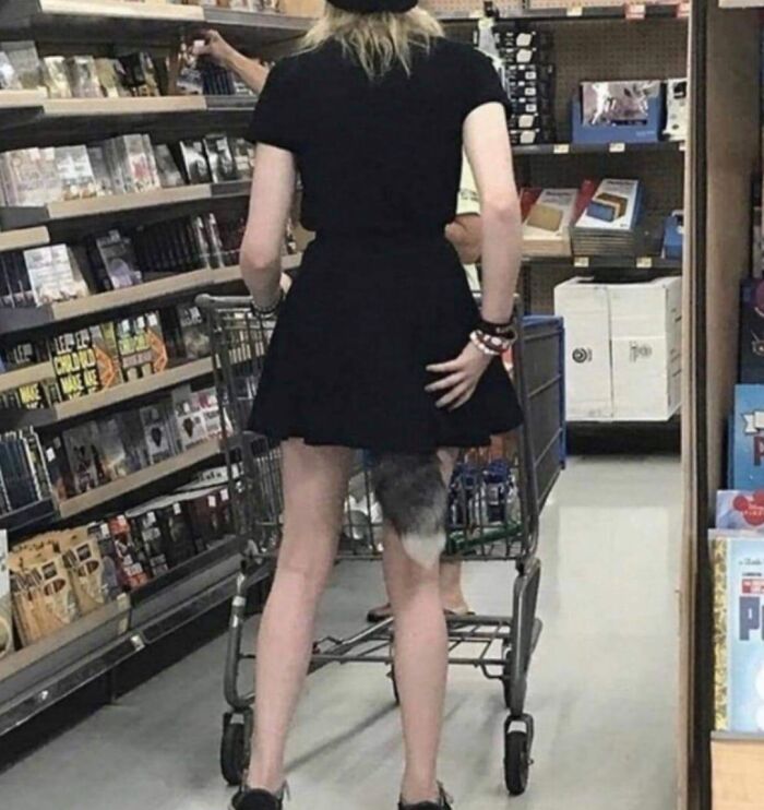 Person shopping in Walmart aisle with shopping cart and an optical illusion creating a weird visual effect on their leg.