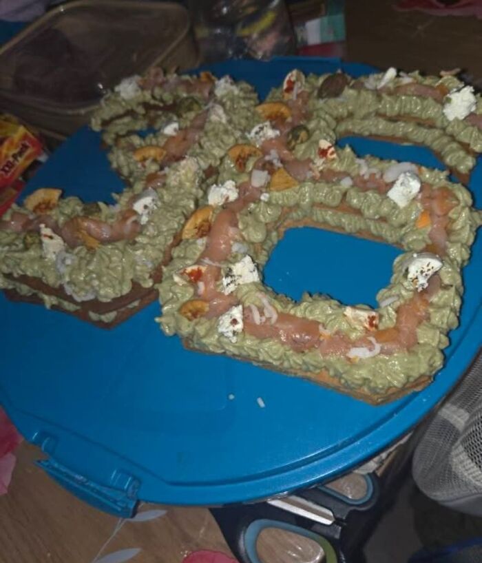 Unappetizing food presentation on a blue plate, featuring greenish frosting and scattered toppings among food pics to be shamed online.