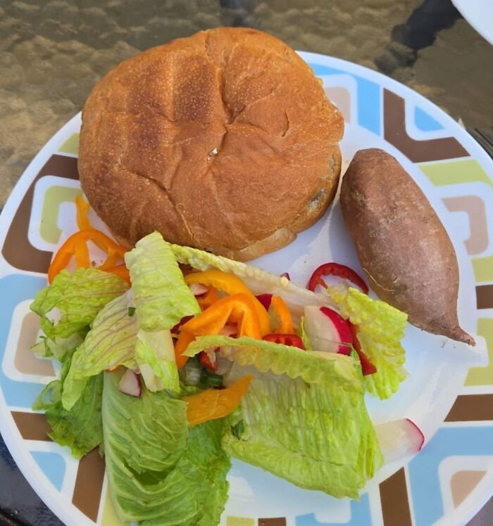 Homemade burger served with simple salad and microwaved sweet potato on a decorative plate food pics to be shamed online