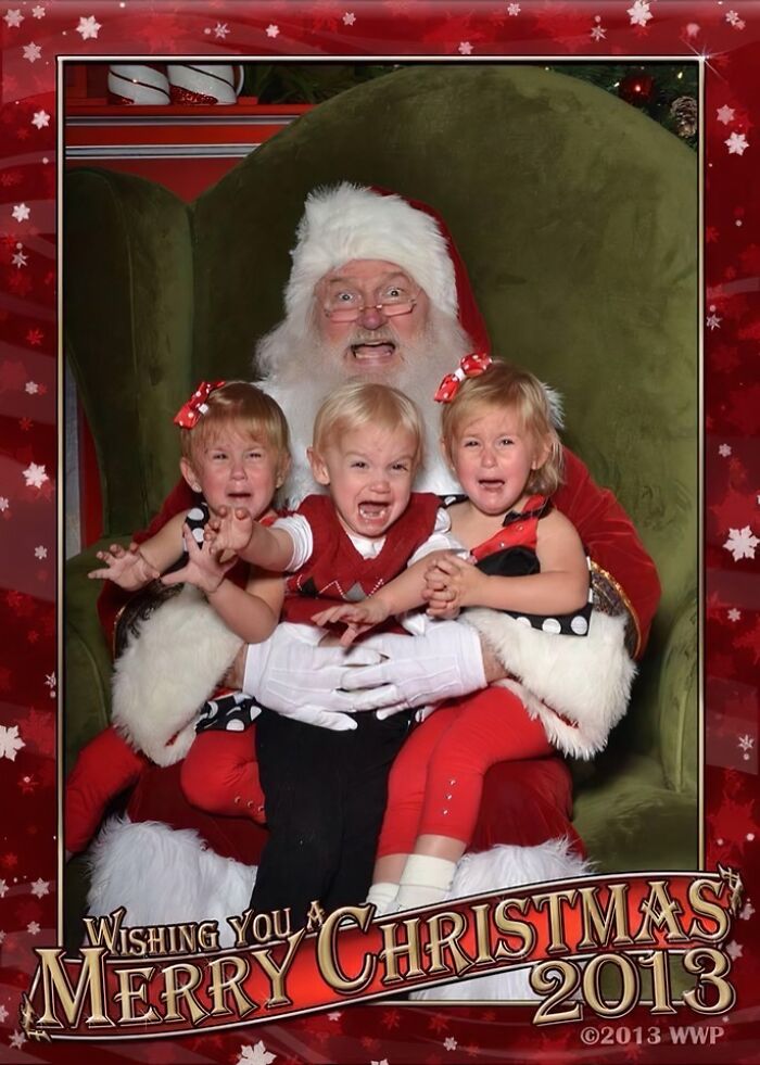 Santa holding three crying children in an awkward family Christmas photo that captures hilarious holiday frustration.