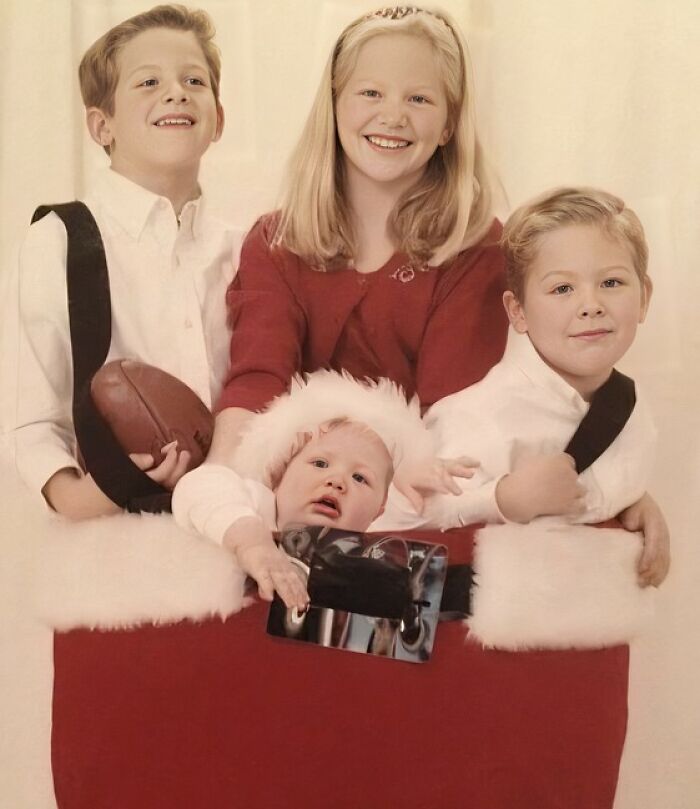 Four children posing in a festive setting, capturing a hilariously awkward family Christmas photo moment.