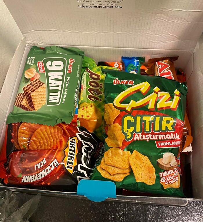 Box of assorted snacks featuring blind boxes for a high stakes Christmas morning game of chance excitement.