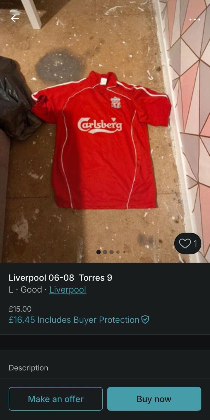 Red Liverpool football jersey with Carlsberg logo laid on dirty floor in unusual Vinted post listing.