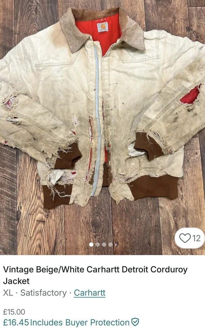 Worn and heavily damaged vintage Carhartt jacket with multiple tears, displayed on wooden floor in a Vinted unhinged post.