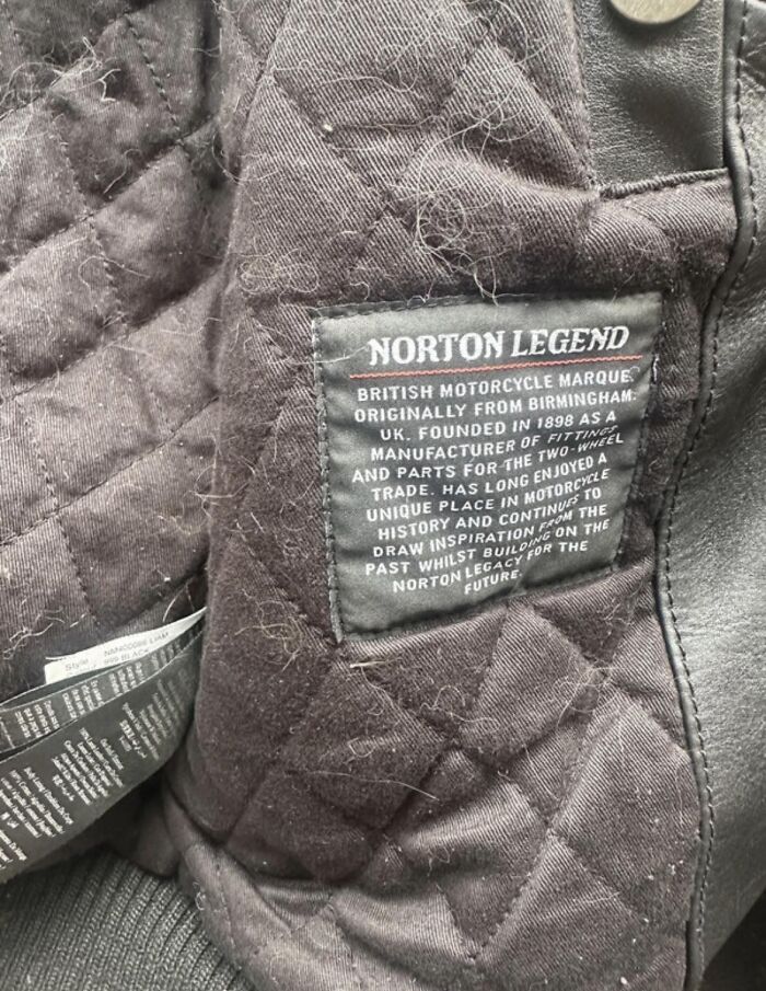 Black quilted fabric with a stitched label describing the Norton Legend motorcycle brand in a second take Vinted post.