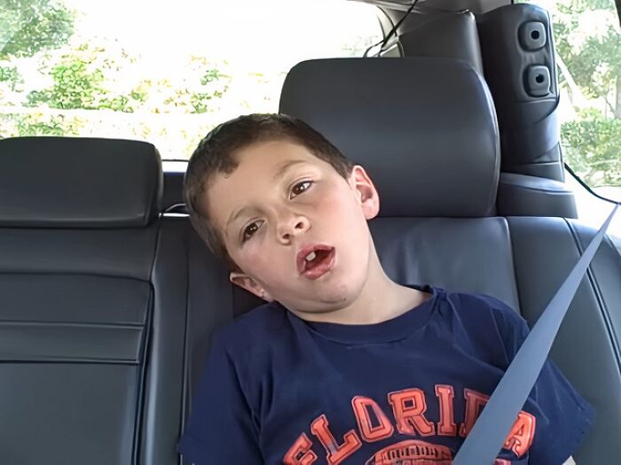 Young boy wearing Florida shirt sitting in car seatbelt, an example of people who went viral randomly and became internet icons.