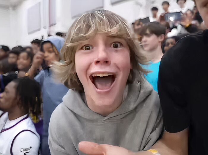 Young person excitedly reacting at crowded event, capturing the moment people went viral and became internet icons.