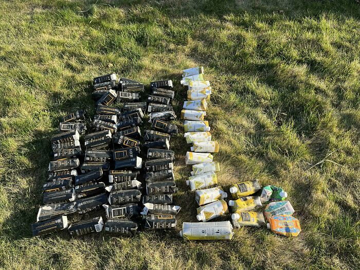 Rows of discarded drink cartons and sachets on grass, example of next-level jerks littering