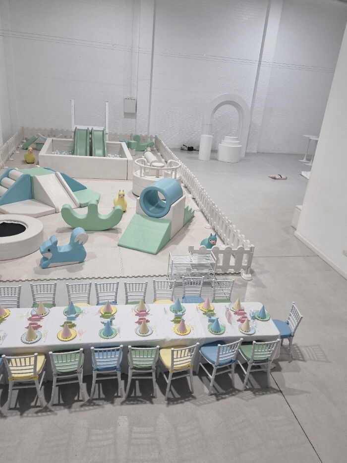 Liminal space featuring pastel play area and empty chairs, evoking a creepy backrooms atmosphere.