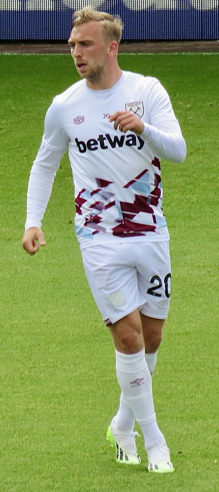 Jarrod Bowen in West Ham warm-up kit on the field, showcasing his bio and career highlights in football.