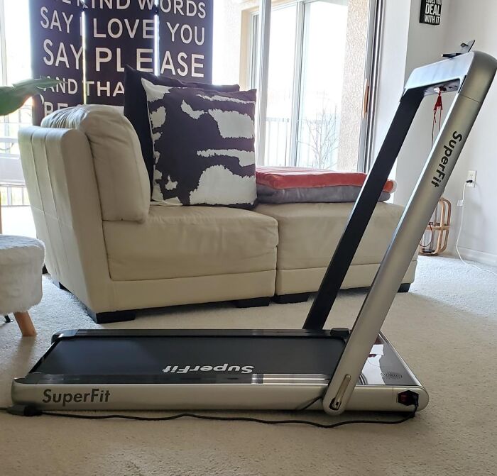 Compact treadmill in an apartment living room, demonstrating apartment friendly ways to smash fitness goals at home.