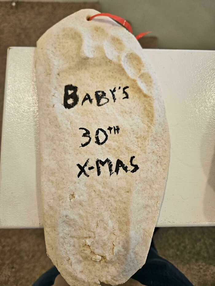 Baby's 30th Christmas keepsake shaped like a footprint, showcasing a humorous and weird memory from 2025.