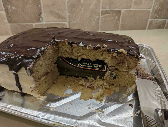Partially eaten chocolate-covered cake with a hidden soda can inside, showing one of the funny pictures from 2025 weirdness.