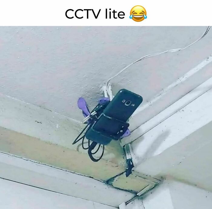 Homemade CCTV setup using a smartphone and cables mounted on a ceiling, showing a funny disassociate meme idea.