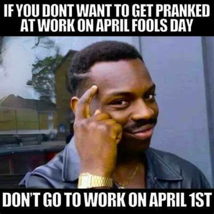 Man with a gold watch smiling and pointing to his head, illustrating funny memes to help disassociate in a fun way.